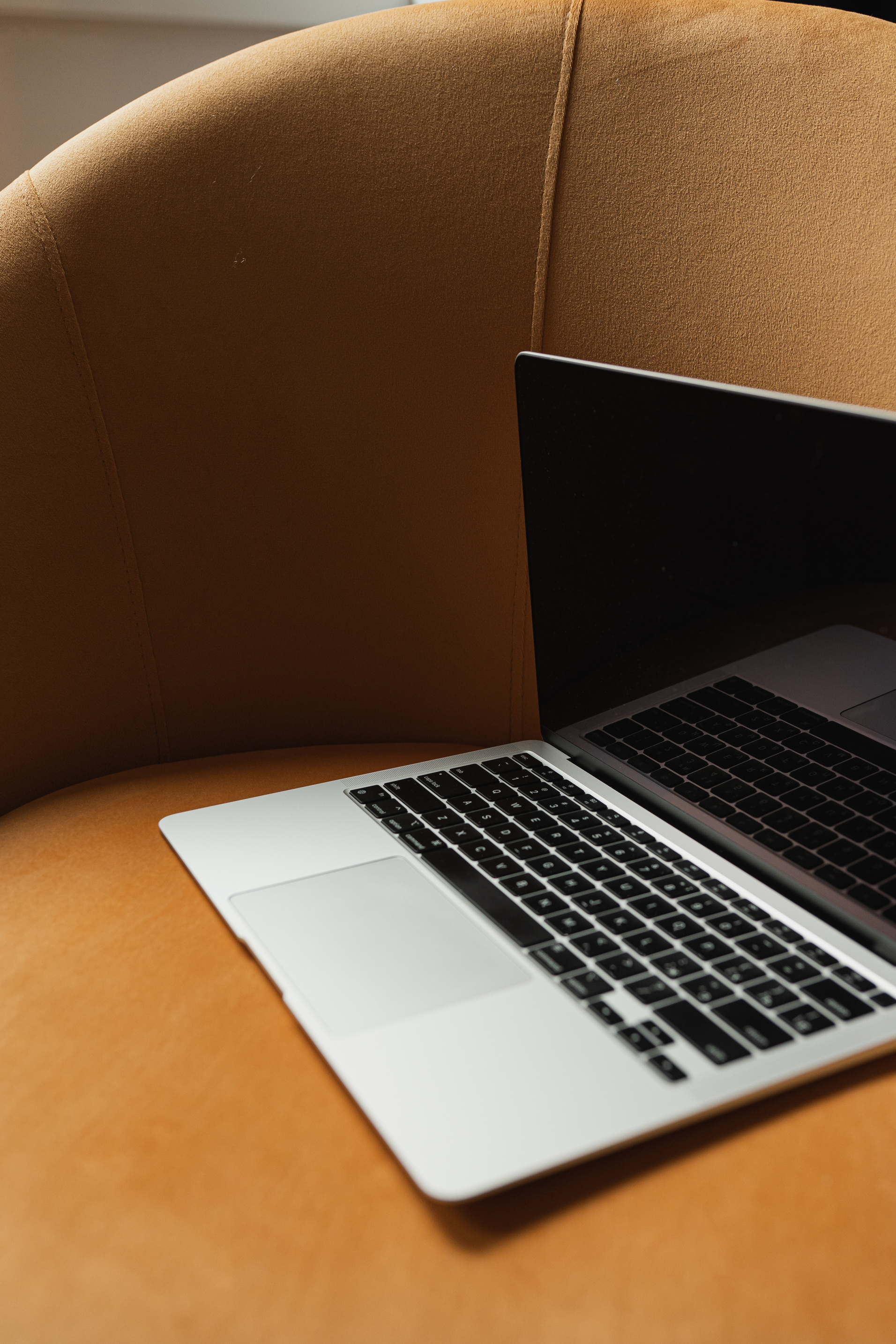 Laptop on a Brown Chair